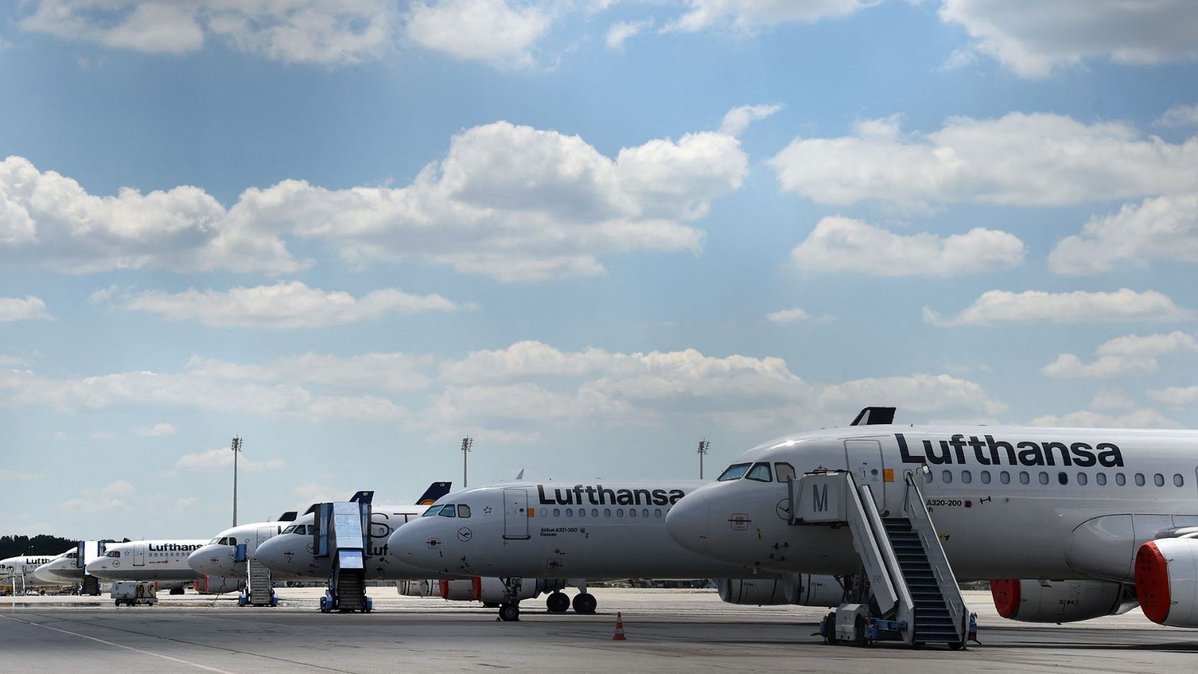 Planes of the German airline Lufthansa are parked at the "Franz-Josef-Strauss" airport in Munich, southern Germany, on May 27, 2020. - Coronavirus-stricken airline group Lufthansa wavered on May 27, 2020 on grabbing a nine-billion-euro ($9.9 billion) German state lifeline, throwing up new turbulence for a rescue that could decide the fate of the historic company. (Photo by Christof STACHE / AFP)