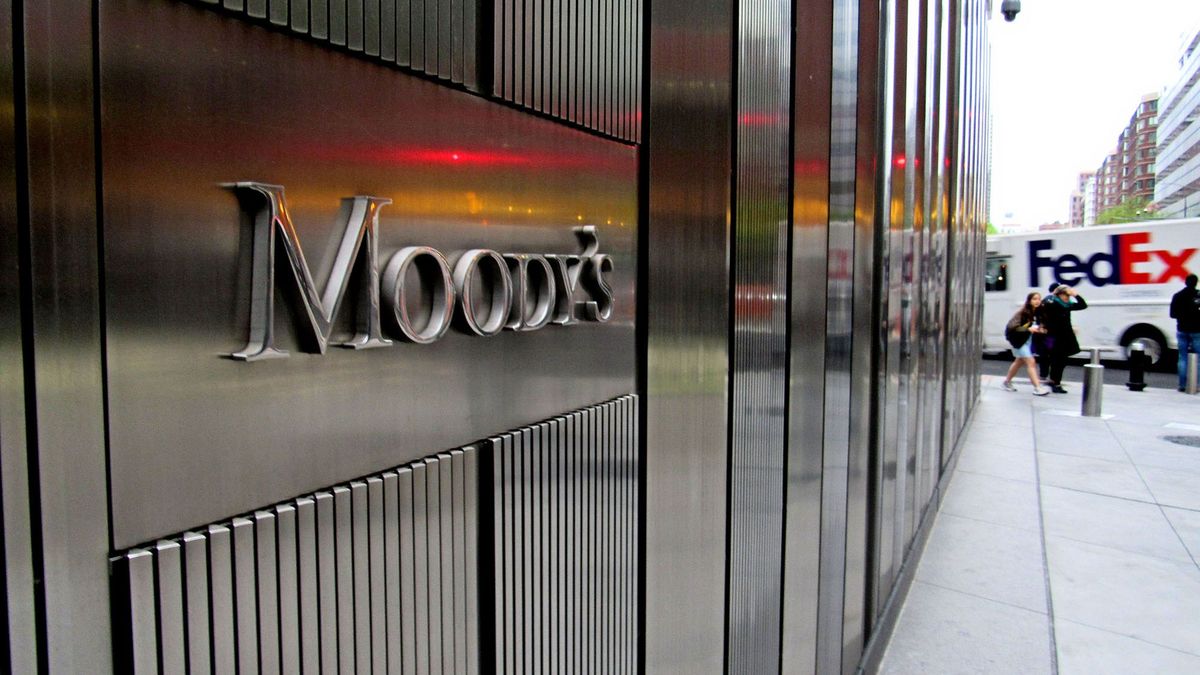 New York, NY/USA-May 3, 2019: The stainless steel facade of 7 World Trade Center and lettering of the Moody's Investor Services sign reflect color from a traffic signal.                             