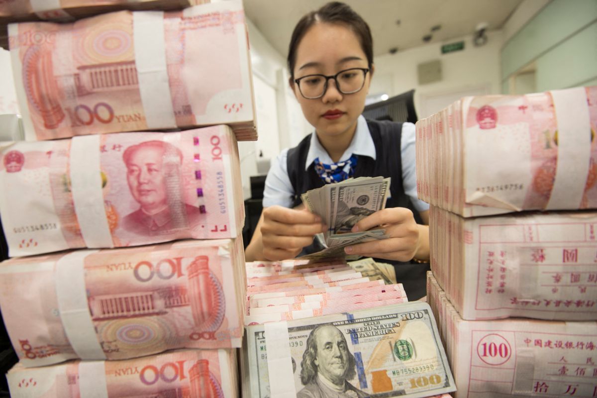 A Chinese clerk counts US dollar notes over RMB (renminbi) yuan notes at a bank in Hai'an city, Nantong city, east China's Jiangsu province, 6 August 2019.

China did not and will not use exchange rates as a measure to cope with trade disputes, and the United States labeling the country as a "currency manipulator" is inconsistent with the quantitative criteria set by the US Treasury itself, the central bank said on Tuesday (6 August 2019). (Photo by Xu jingbai / Imaginechina / Imaginechina via AFP)