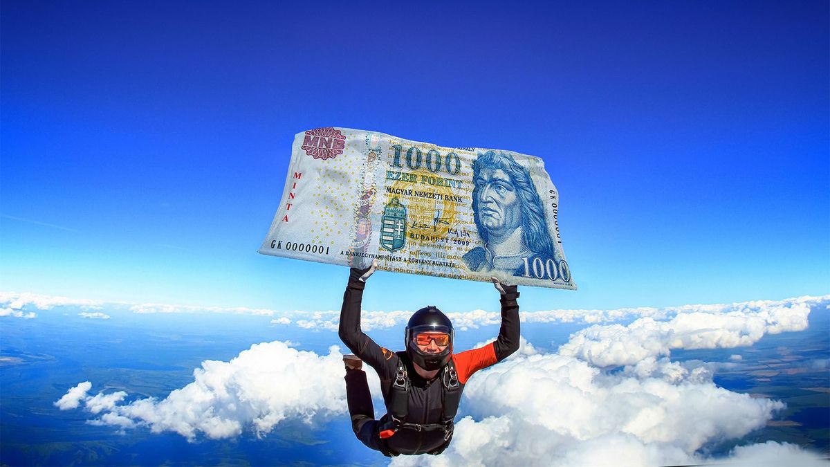 forintgyengülés 1000 forint. Parachutist is flying a flag of forint bill. National investment. Fly men in black suit. 