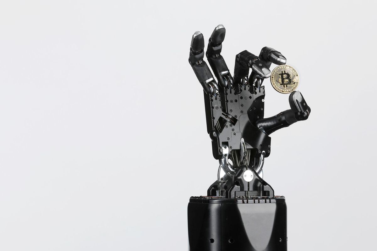 The Shadow Dexterous robotic hand, manufactured by The Shadow Robot Company, holds a coin representing Bitcoin cryptocurrency during a demonstration of its agility in an arranged photograph in London, U.K., on Wednesday, Feb. 14, 2018. The hand with ultra-sensitive touch sensors on the fingertips, including the thumb and even the flex of the palm for the little finger, provides unique capabilities for problems that require the closest approximation of the human hand currently possible. Photographer: Luke MacGregor/Bloomberg via Getty Images 921135426