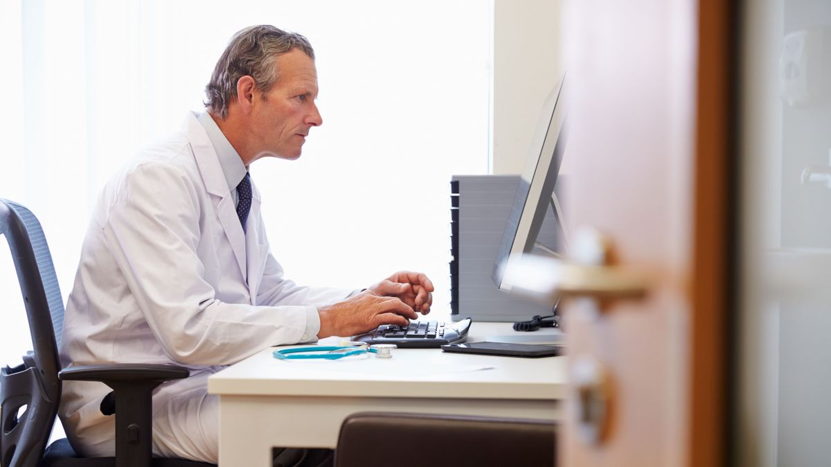 Male,Doctor,In,Office,Working,At,Computer