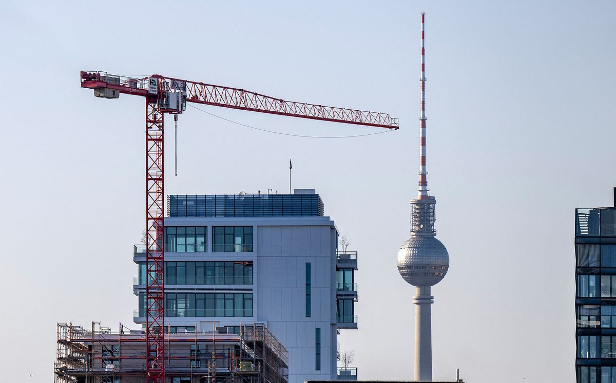 21 March 2022, Berlin: A construction crane works on a high-rise building construction site against the backdrop of the Berlin TV Tower. Photo: Monika Skolimowska/dpa-Zentralbild/ZB (Photo by Monika Skolimowska / dpa-Zentralbild / dpa Picture-Alliance via AFP)
