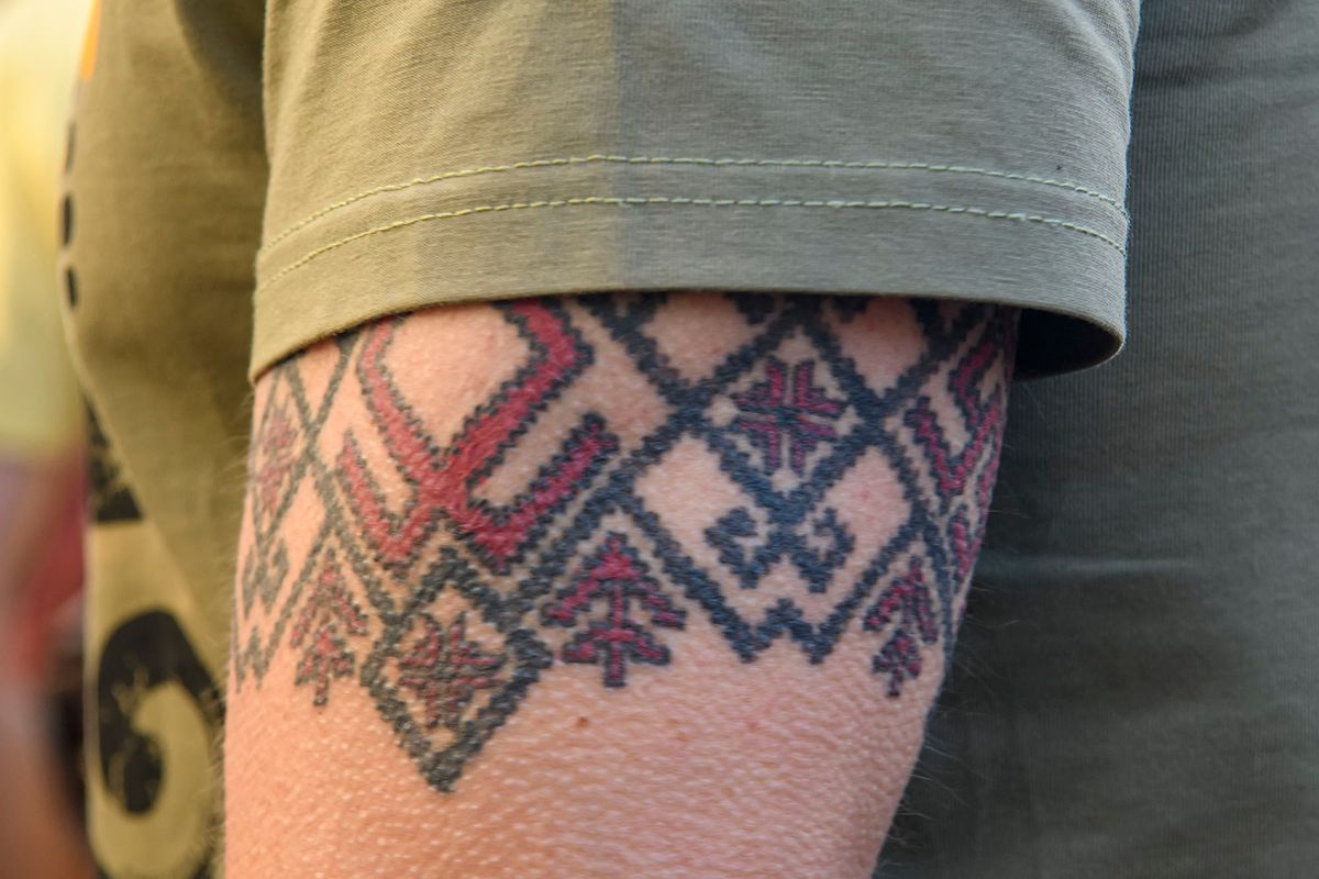 Demonstrator with a tattoo on his arm in the form of a traditional Ukrainian pattern  during an anti-presidential rally outside the President's office organised by opposition parties and movements to demand his impeachment for high treason, in Kyiv on June 28, 2021.  (Photo by Maxym Marusenko/NurPhoto) (Photo by Maxym Marusenko / NurPhoto / NurPhoto via AFP)