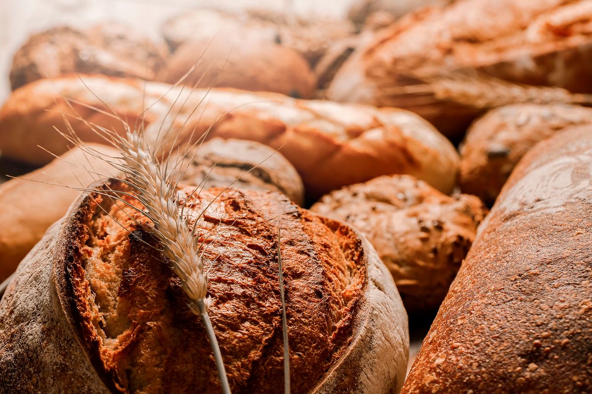 1309448945 Various kind of bread with wheat  top view.  Bakery concept. Copy space for text.