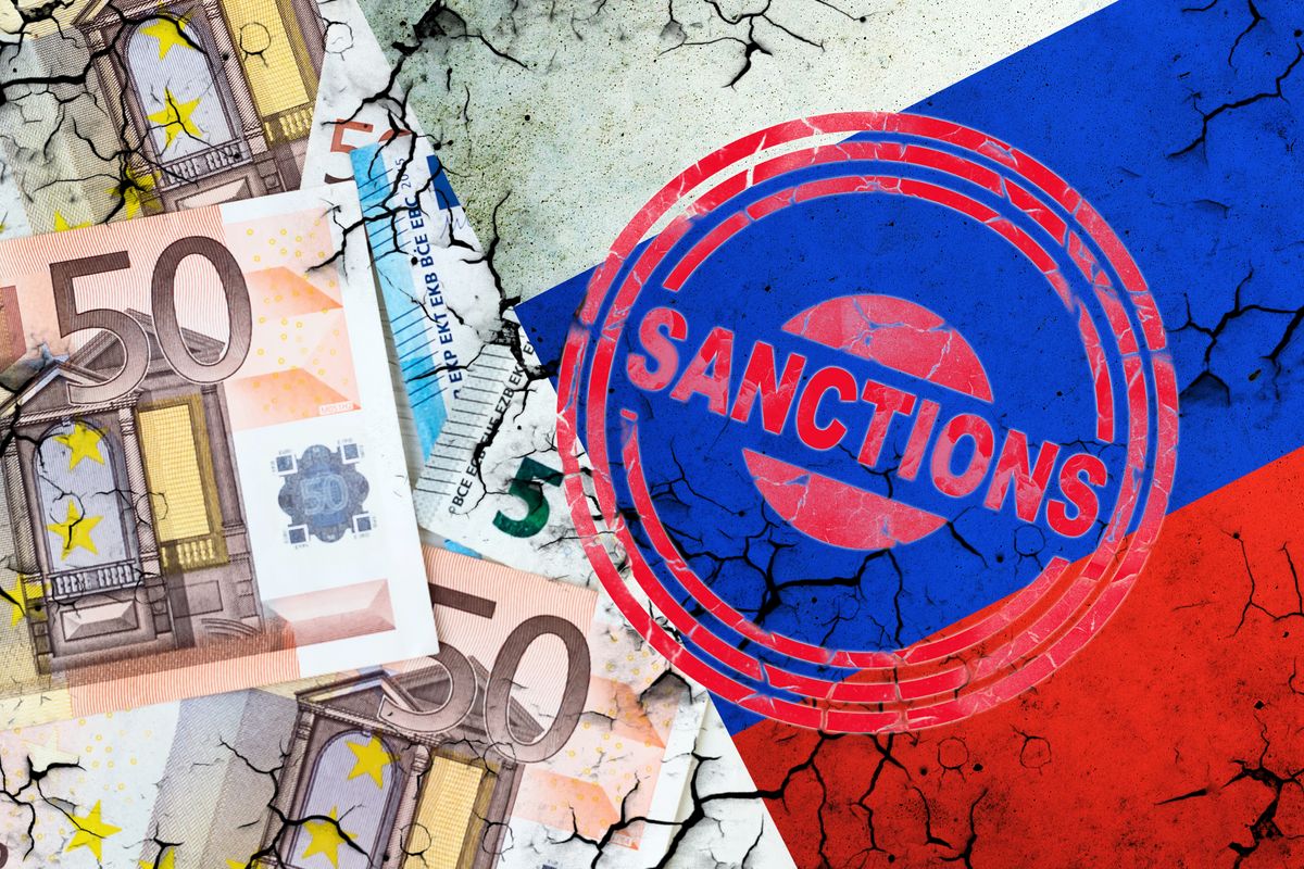 Euro bills, and a cracked Russian flag. Sanction stamp. The concept of sanctions against Russia. Finance.