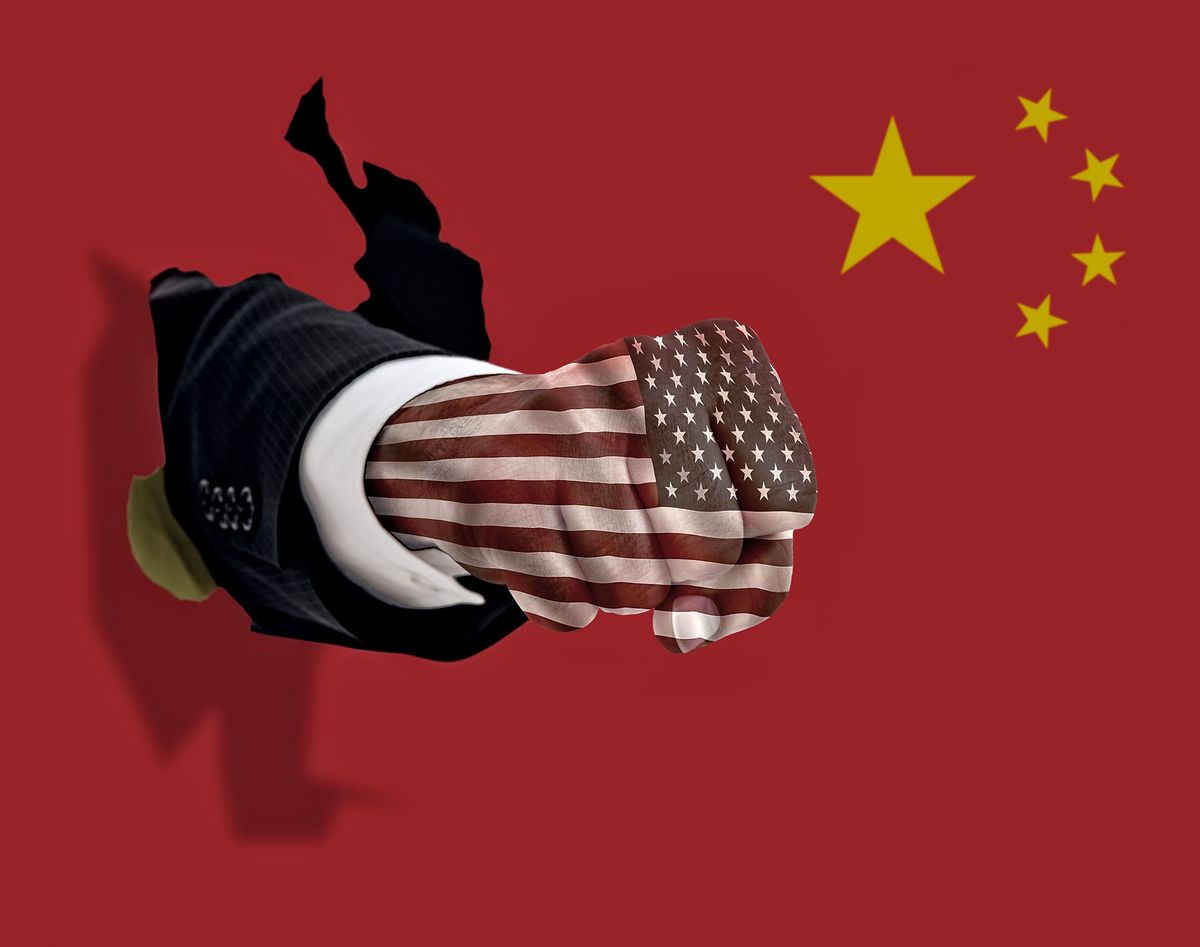 1171962573 This is a conceptual photo of an American fist punching through a Chinese flag