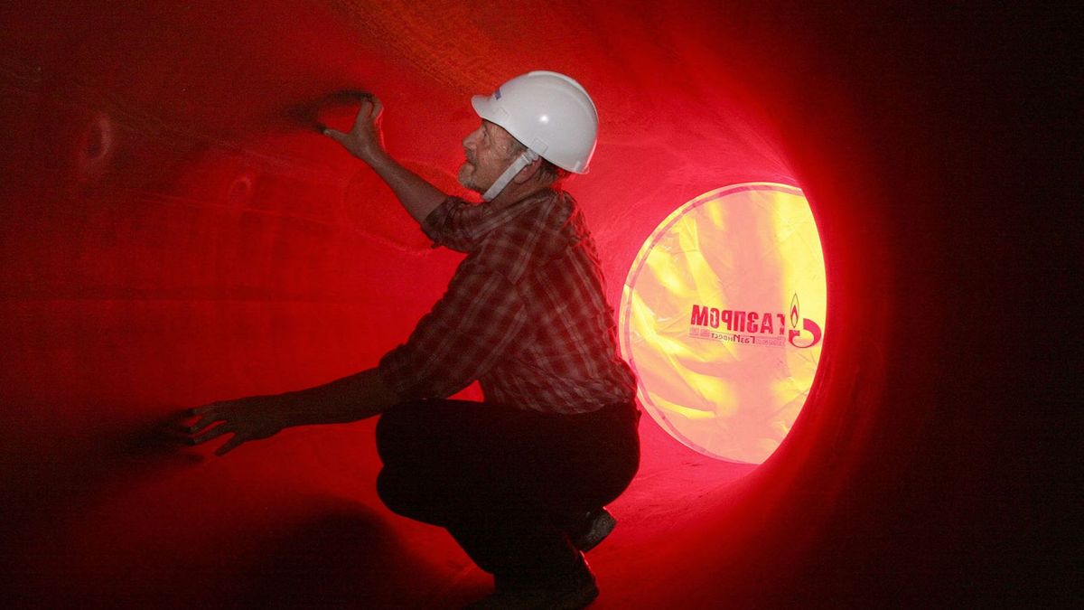 A worker examines the internal part of a pipe on the North European Gas pipeline (NEGP) 23 June 2006 in the region of Leningrad. The 4.7-billion euro project,   managed by Russian energy giant Gazprom and German companies BASF and E.ON, began last year.  A top official of Gazprom warned in an interview released yesterday that Europe could expect disruptions in its gas supplies due to a bitter pricing dispute between Gazprom and the Ukraine. AFP PHOTO / ALEXANDER DROZDOV (Photo by ALEXANDER DROZDOV / INTERPRESS / AFP)