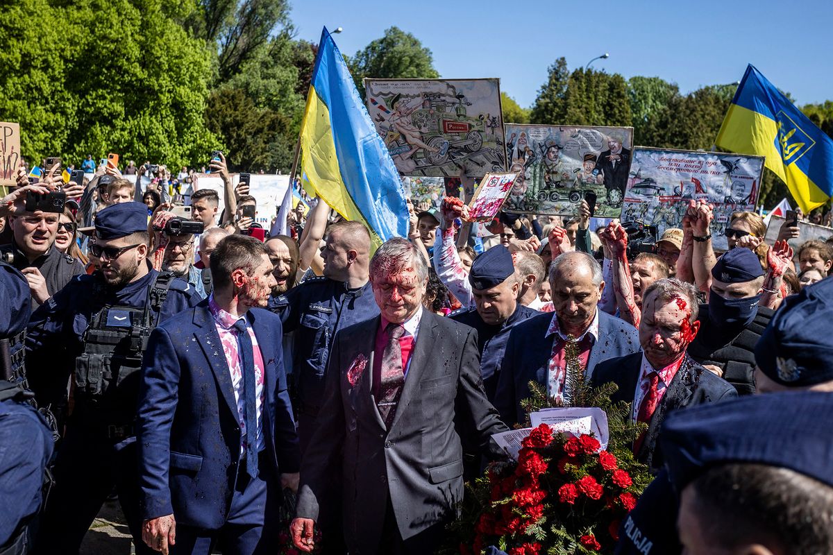 Russian Ambassador to Poland, Ambassador Sergey Andreev reacts after being covered with red paint during a protest for peace in Ukraine in Warsaw, Poland on May 9, 2022, on the day of the 77th anniversary of the 1945 Soviet victory against Nazi Germany. (Photo by Wojtek RADWANSKI / AFP)
