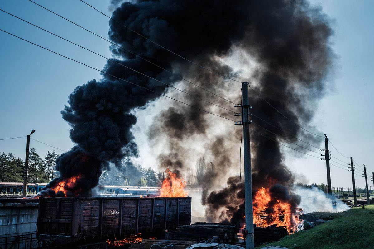 This photograph shows a railway wagon and sleepers burning after a shelling near the Lyman station in Lyman, eastern Ukraine, on April 28, 2022, amid the Russian invasion of Ukraine. (Photo by Yasuyoshi CHIBA / AFP)