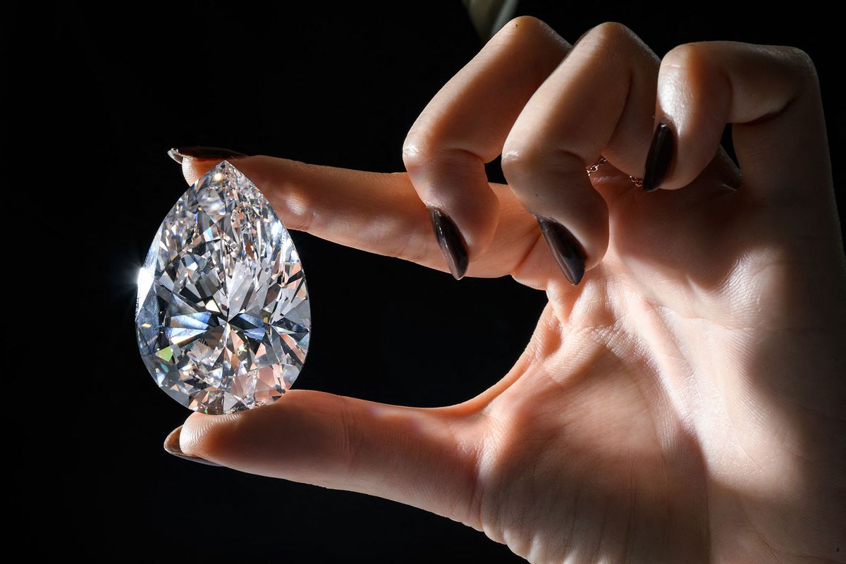 This picture taken on May 6, 2022 in Geneva shows "The Rock", a 228,31 carats pear-shaped white diamond (estimate: USD 20,000,000-30,000,000) mined and polished in South Africa over two decades ago, which is the largest white diamond ever to appear for sale at auction, according to Christieís auction house. - The Rock will be offered on May 11, 2022 in Geneva during a "Christieís Magnificent Jewels" sale, alongside a yellow diamond, with part of the proceeds going to the International Committee of the Red Cross. (Photo by Fabrice COFFRINI / AFP)
