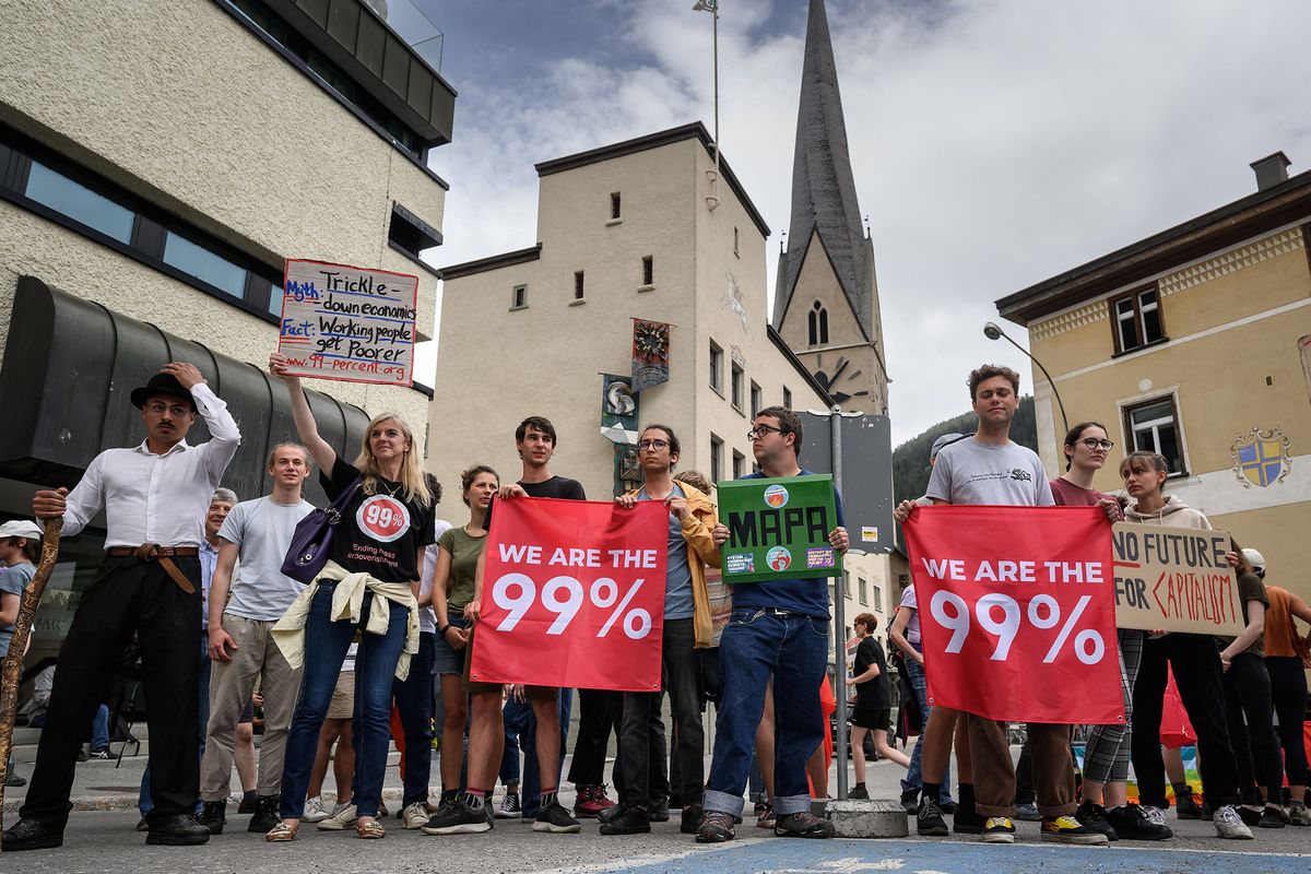 Protesters take part in a demonstration against the World Economic Forum (WEF) during the WEF annual meeting in Davos on May 22, 2022. (Photo by Fabrice COFFRINI / AFP)