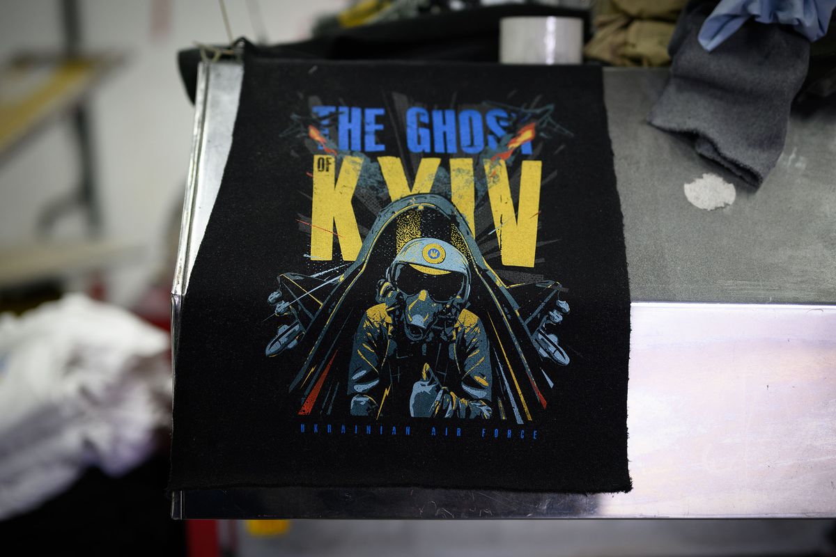 LVIV, UKRAINE - APRIL 22: A t-shirt featuring "The Ghost of Kyiv" is seen at the Aviatsiya Halychyny clothing company on April 22, 2022 in Lviv, Ukraine. The company has been producing shirts featuring pro-Ukrainian slogans and images for sale in stores across the region. Lviv has served as a stopover and shelter for the millions of Ukrainians fleeing the Russian invasion, either to the safety of nearby countries or the relative security of western Ukraine. (Photo by Leon Neal/Getty Images) 1392956768