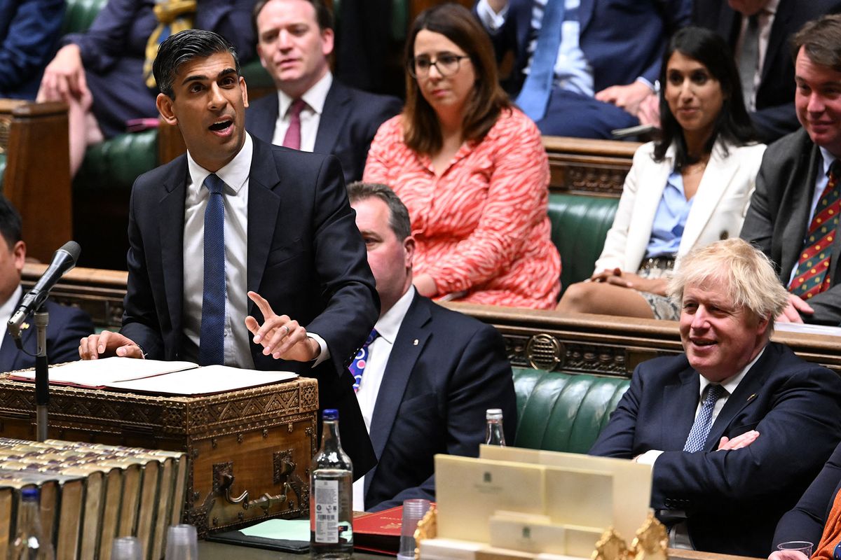 A handout photograph released by the UK Parliament shows Britain's Chancellor of the Exchequer Rishi Sunak (L) making a statement on the cost of living crisis in the House of Commons on May 26, 2022. - Britain's finance minister Rishi Sunak on Thursday unveiled a support package for consumers hit by soaring energy bills, reportedly with help from a controversial windfall tax on oil giants. (Photo by JESSICA TAYLOR / UK PARLIAMENT / AFP) / RESTRICTED TO EDITORIAL USE - NO USE FOR ENTERTAINMENT, SATIRICAL, ADVERTISING PURPOSES - MANDATORY CREDIT " AFP PHOTO / Jessica Taylor /UK Parliament"