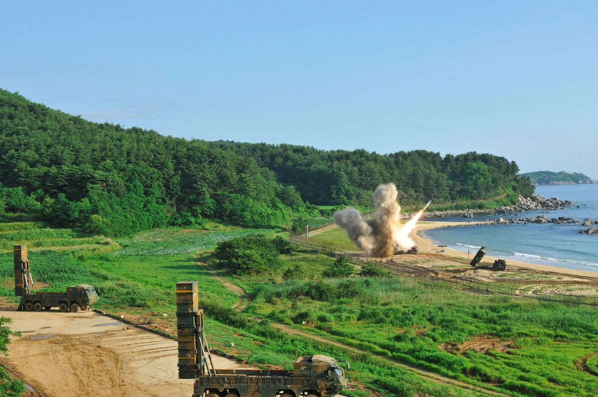 This handout photo taken on July 5, 2017 and provided by US Forces Korea (USFK) in Seoul shows US M270 Multiple Launch Rocket System (R) firing an MGM-140 Army Tactical Missile into the East Sea from an undisclosed location on South Korea's east coast during a South Korea-US joint missile drill aimed to counter North Koreaís ICBM test. - South Korea and the United States fire a barrage of missiles in a warning to the North, after Pyongyang tested an intercontinental missile for the first time and its leader Kim Jong-Un called it a 'gift' to 'American bastards'. (Photo by Handout / various sources / AFP) 