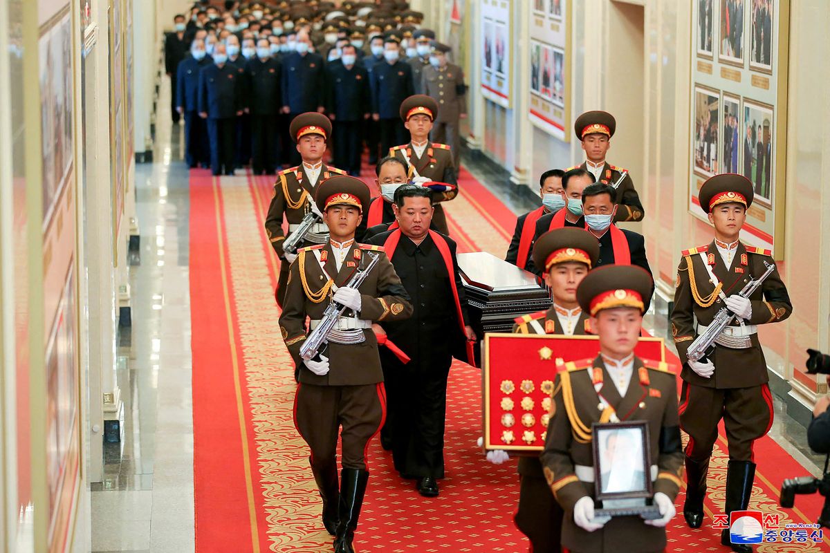 This picture taken on May 22, 2022 and released from North Korea's official Korean Central News Agency (KCNA) on May 23 shows North Korean leader Kim Jong Un (C-L) carrying the coffin of late Hyon Chol Hae, Marshal of the Korean People's Army and general adviser to the ministry of national defence during his funeral at the April 25 House of Culture in Pyongyang. (Photo by KCNA VIA KNS / AFP)