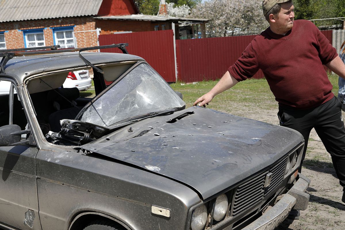 8189803 12.05.2022 A man shows a car damaged by a shelling as Russia's military operation in Ukraine continues, in the village of Solokhi in Belgorod region bordering Ukraine, Russia. Regional authorities said one person was killed and six injured by Ukrainian shelling. Taisia Liskovets / Sputnik (Photo by Taisia Liskovets / Sputnik / Sputnik via AFP)