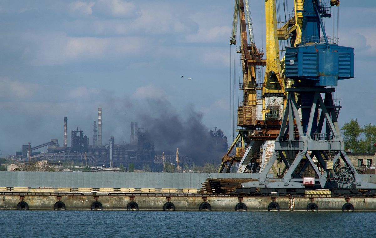 ALTERNATIVE CROP - Smoke rises above the Azovstal steel plant in the city of Mariupol on April 29, 2022, amid the ongoing Russian military action in Ukraine.The mayor of the destroyed Ukrainian city of Mariupol said on May 4, 2022 that contact was lost with Ukrainian forces holed up in the Azovstal steel plant amid fierce battles with Russian troops. - *EDITOR'S NOTE: This picture was taken during a media trip organised by the Russian army.* (Photo by Andrey BORODULIN / AFP)
