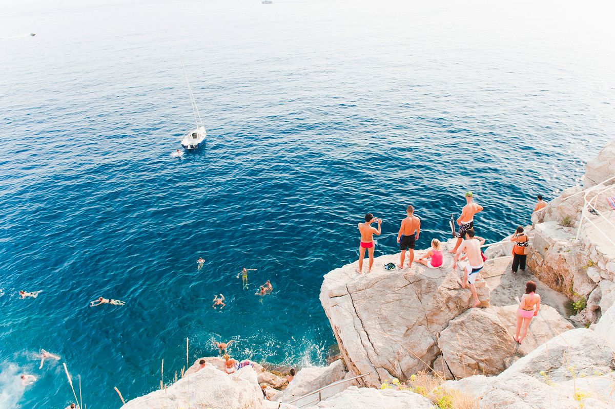 Tourists swimming at Buza Bar, aka Cafe Buza, Dubrovnik, Croatia