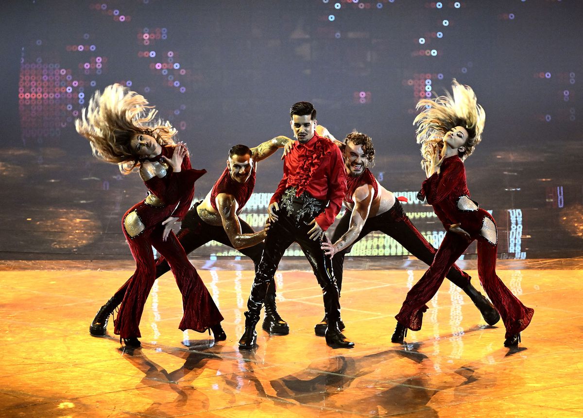 Singer Andrei-Ionut Ursu, a.k.a. "WRS" (C), performs on behalf of Romania during the final of the Eurovision Song contest 2022 on May 14, 2022 at the Pala Alpitour venue in Turin. (Photo by Marco BERTORELLO / AFP)