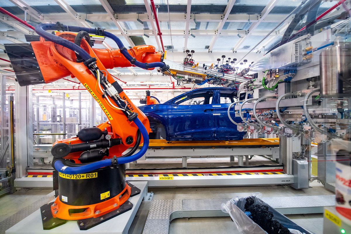 20 May 2022, Lower Saxony, Emden: Robots assemble components of the ID.4 at the VW plant. Volkswagen has started series production of the all-electric ID.4 compact SUV at its plant in Emden, East Frisia. After the start-up phase, 4000 e-vehicles per week are to be produced in Emden by the end of the year. Photo: Sina Schuldt/dpa (Photo by Sina Schuldt / DPA / dpa Picture-Alliance via AFP)