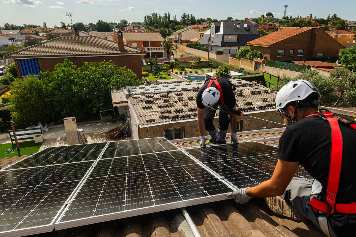 1240916208 Engineers from Holaluz-Clidom SA install solar panels onto the roof of a residential building in Madrid, Spain, on Tuesday, May 24, 2022. Solar energy installations on rooftops have been surging in Spain, giving more hope that at least one European country can speed up its transition away from gas power in the wake of Russias invasion in Ukraine. Photographer: Emilio Parra Doiztua/Bloomberg via Getty Images