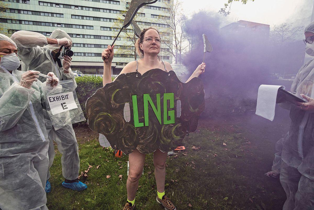 1240434378 AMSTERDAM, NETHERLANDS - 2022/05/03: A female Ocean Rebellion demonstrator plays the role of a cloud of LNG surrounded by activists dressed as climate crime investigators, during a protest performance outside the Global LNG Bunkering Summit. During the Global LNG Bunkering Summit 2022, the industry claimed that LNG or liquefied natural gas is the cleaner than heavy fuel oil. LNG has significantly lower CO2 emissions, and almost non-existant particle emissions. The aim of the 3-day conference is to initiate the start of Liquid Natural Gas (LNG) in shipping and imports, and set-up the required infrastructure. The IPCC”s latest report focusing on climate mitigation makes clear that fossil gas in the form of LNG is not a solution for shipping”s decarbonization. There are currently over 785 new cargo ships on order globally, with over 400 being built to run on fossil LNG. (Photo by Charles M Vella/SOPA Images/LightRocket via Getty Images)