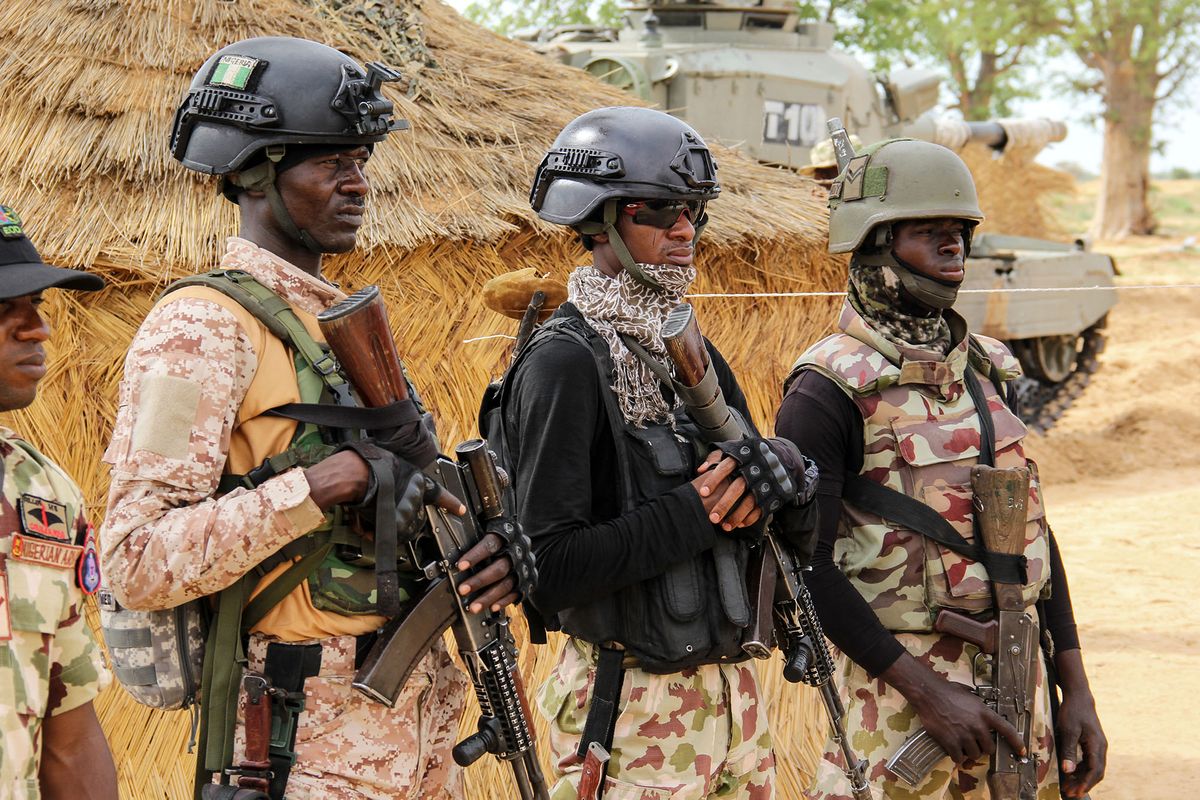 Nigerian Army soldiers stand at a base in Baga on August 2, 2019. - Intense fighting between a regional force and the Islamic State group in West Africa (ISWAP) has resulted in dozens of deaths, including at least 25 soldiers and more than 40 jihadists, in northeastern Nigeria. ISWAP broke away from Boko Haram in 2016 in part due to its rejection of indiscriminate attacks on civilians. Last year the group witnessed a reported takeover by more hardline fighters who sidelined its leader and executed his deputy. The IS-affiliate has since July 2018 ratcheted up a campaign of attacks against military targets. (Photo by AUDU MARTE / AFP)
