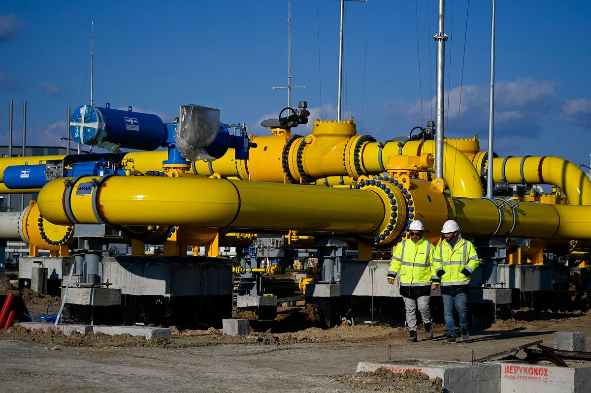 Employees walk at the construction site of a gas metering station, part of the pipeline link between Bulgaria and Greece near the village of the Malko Kadievo, on March 18, 2022. - EU member Bulgaria has been criticised for its almost total dependence on Russia for its annual consumption of about three billion cubic metres of gas. In a bid to secure alternative deliveries, the Balkan country had long planned to link its gas network to those of its neighbours -- Greece, Serbia and Romania -- but the projects were severely delayed by administrative hurdles. (Photo by Nikolay DOYCHINOV / AFP)