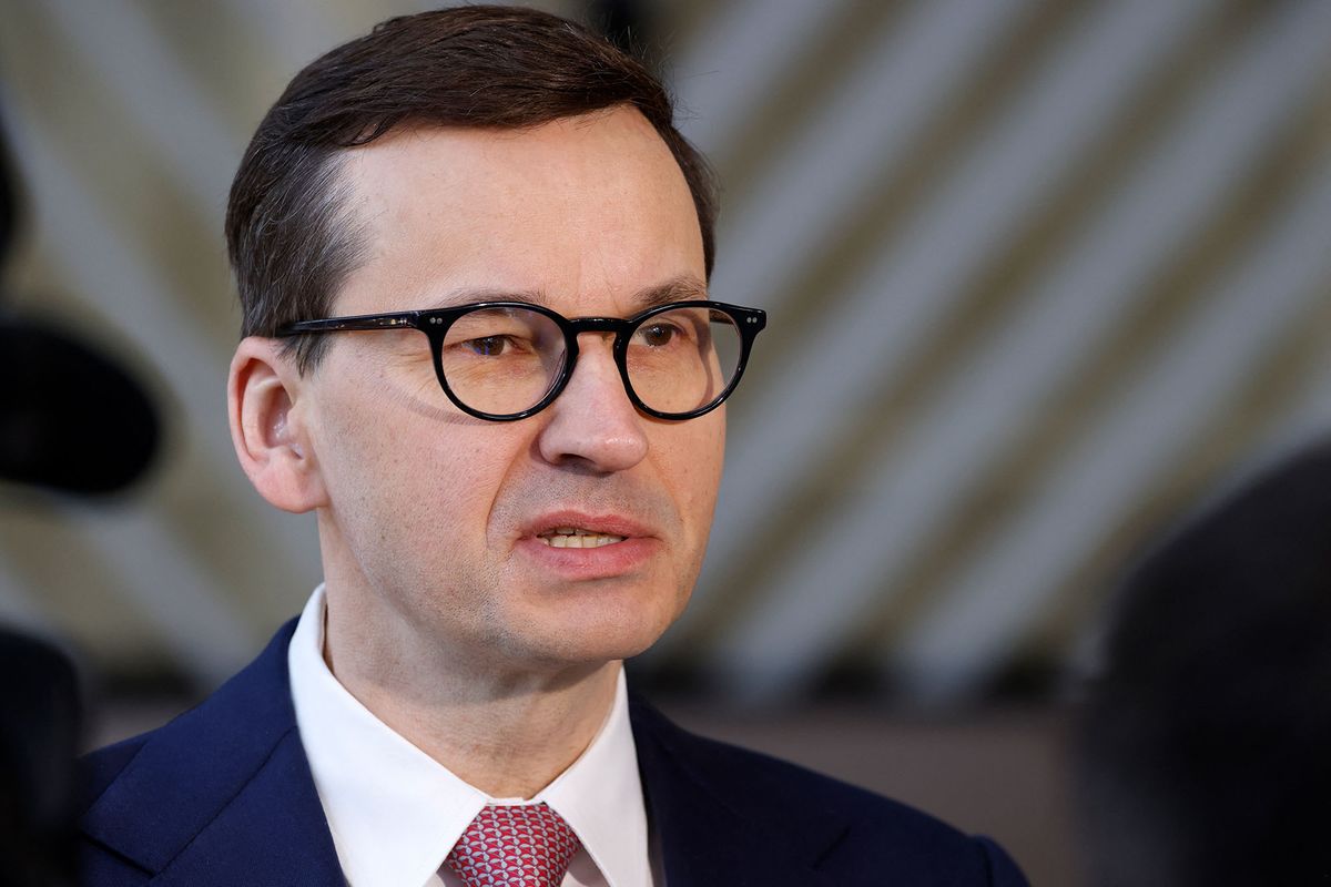Poland's Prime Minister Mateusz Morawiecki talks to the press as he arrives for the second day of a European Union (EU) summit at the EU Headquarters, in Brussels on March 25, 2022. (Photo by Ludovic MARIN / AFP)