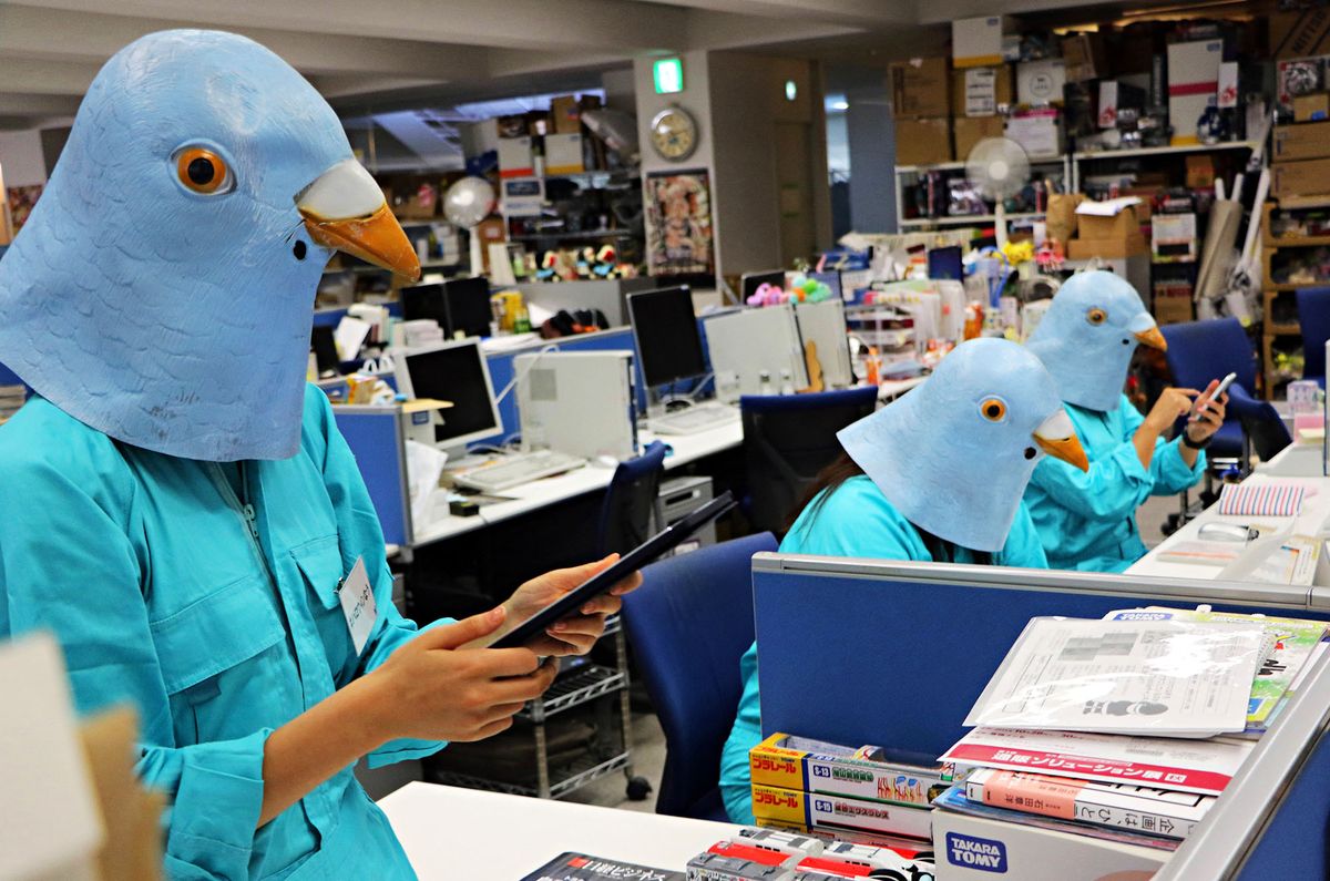 Employees of Japanese toy company Tomy dressed as Twitter birds work at their desks during the company's Halloween Day event at the company headquarters in Tokyo on October 27, 2015. Employees for the Japanese toymaker were allowed to wear their favourite costumes in observance of the holiday.  AFP PHOTO / Yoshikazu TSUNO (Photo by Yoshikazu TSUNO / AFP)