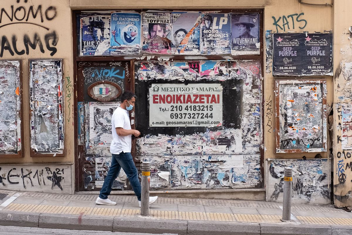 A man seen walking past a closed store in the center of Athens, Greece on May 26, 2021. (Photo by Nikolas Kokovlis/NurPhoto) (Photo by Nikolas Kokovlis / NurPhoto / NurPhoto via AFP)
