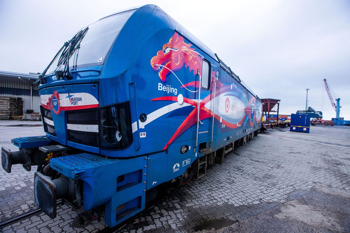 11 February 2022, Mecklenburg-Western Pomerania, Mukran: A MUkran Port locomotive with Chinese motifs, the Astian dragon's head and the lettering "Beijing" stands at the arrival of the first ship of a new "Silk Road" connection between China and Germany at the port of Mukran. The containers from Wuhan in China cover part of the route by water and are loaded back onto rail cars on the island of R¸gen. Photo: Jens B¸ttner/dpa-Zentralbild/dpa (Photo by JENS BUTTNER / dpa-Zentralbild / dpa Picture-Alliance via AFP)