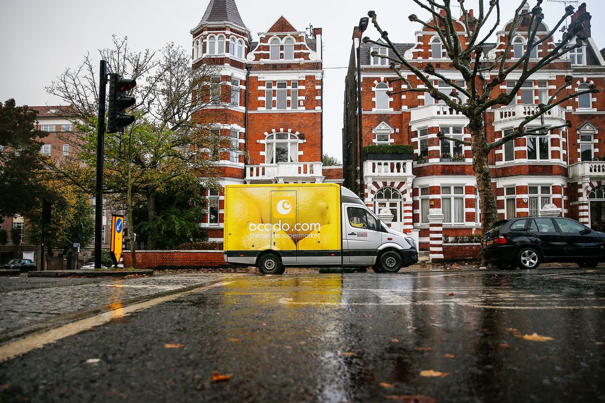 1229181075 An employee of Ocado Group Plc leaves his delivery truck parked as he makes a grocery delivery to a residential home in the St John's Wood district of London, U.K., on Thursday, Oct. 8, 2020. Covid-19 lockdown enabled online and app-based grocery delivery service providers to make inroads with customers they had previously struggled to recruit, according the Consumer Radar report by BloombergNEF. Photographer: Hollie Adams/Bloomberg via Getty Images