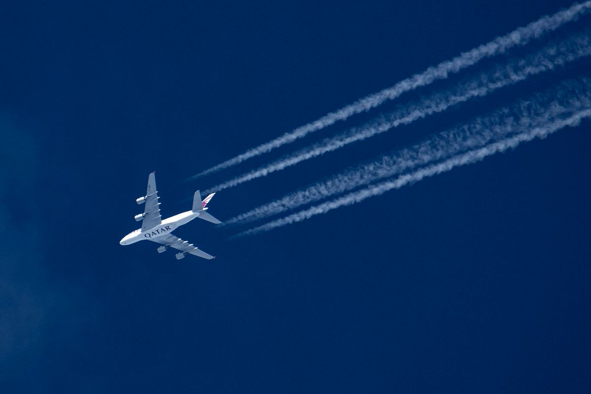 Qatar Airways Airbus A380 double decker aircraft overfly at 40.000 feet in the blue sky during a sunny day over Europe, performing a flight connection from the capital of Qatar Doha airport to London Heathrow LHR in the UK. A388 overflying wide-body jet airplane has the QATAR logo inscription print on the bottom of the fuselage and is leaving behind contrails or condensation trail, a white vapor line. The A380 is a large wide-body airliner, the world's largest passenger plane. The specific quadjet double-deck has the registration A7-APH and is powered by 4x EA Engine Alliance GP7200 jet engines. QR is the state-owned flag carrier of Qatar, member of Oneworld airline alliance group. The aviation industry and passenger traffic are phasing a difficult period with the Covid-19 coronavirus pandemic having a negative impact on the travel business industry with fears of the worsening situation due to the new Omicron variant mutation at the fifth wave. Eindhoven, the Netherlands on February 11, 2022 (Photo by Nicolas Economou/NurPhoto) (Photo by Nicolas Economou / NurPhoto / NurPhoto via AFP)