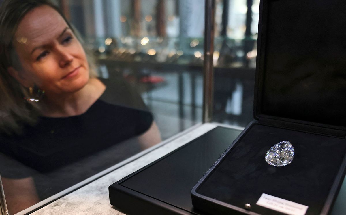 A giant diamond nicknamed "The Rock" is displayed at Christie's auction house in Dubai on March 25, 2022, ahead of an auction where it is expected to fetch up to $30 million. - The 228.31-carat pear-shaped gem, which was mined and polished in South Africa more than 20 years ago, is the largest white diamond ever to come to auction, said Christie's. After making its debut at Christie's Dubai, where it will be displayed from March 26-29, The Rock will travel to Taipei, New York and Geneva, where it will be auctioned on May 11. (Photo by Karim SAHIB / AFP)