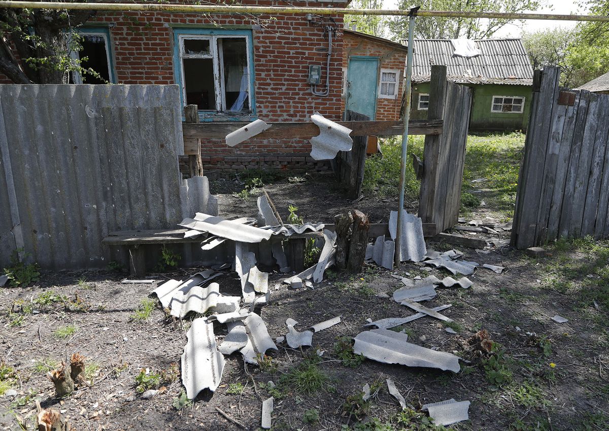 8189814 12.05.2022 A view shows a damaged fence of a residential house after a shelling as Russia's military operation in Ukraine continues, in the village of Solokhi in Belgorod region bordering Ukraine, Russia. Regional authorities said one person was killed and seven injured by Ukrainian shelling. Taisia Liskovets / Sputnik (Photo by Taisia Liskovets / Sputnik / Sputnik via AFP)