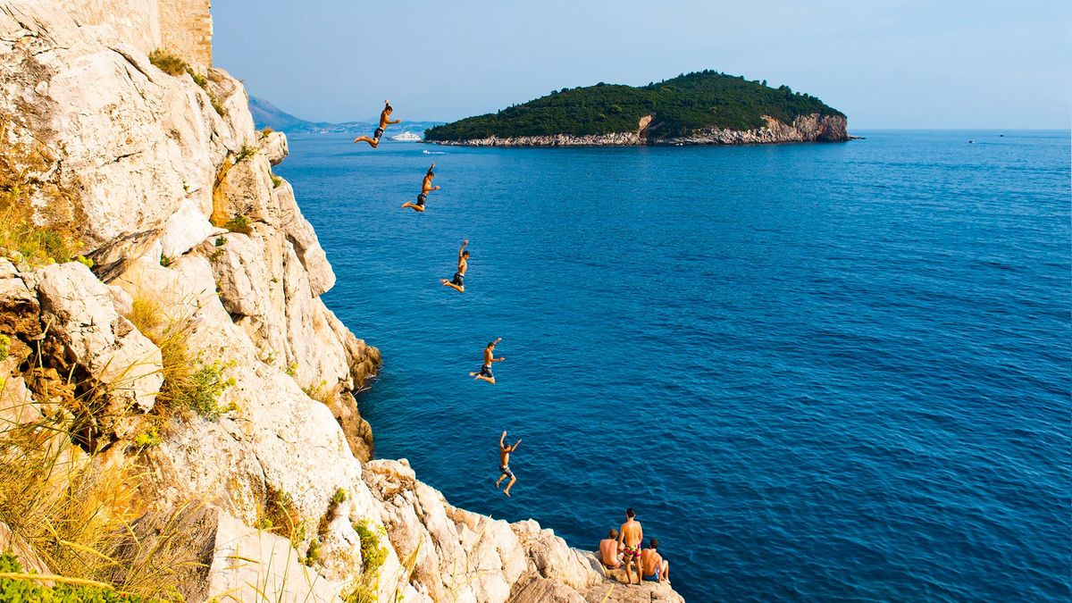 1284258677 Photo of cliff jumping at Buza Bar, aka Cafe Buza, Dubrovnik, Croatia. (Photo by: Matthew Williams-Ellis/Universal Images Group via Getty Images)