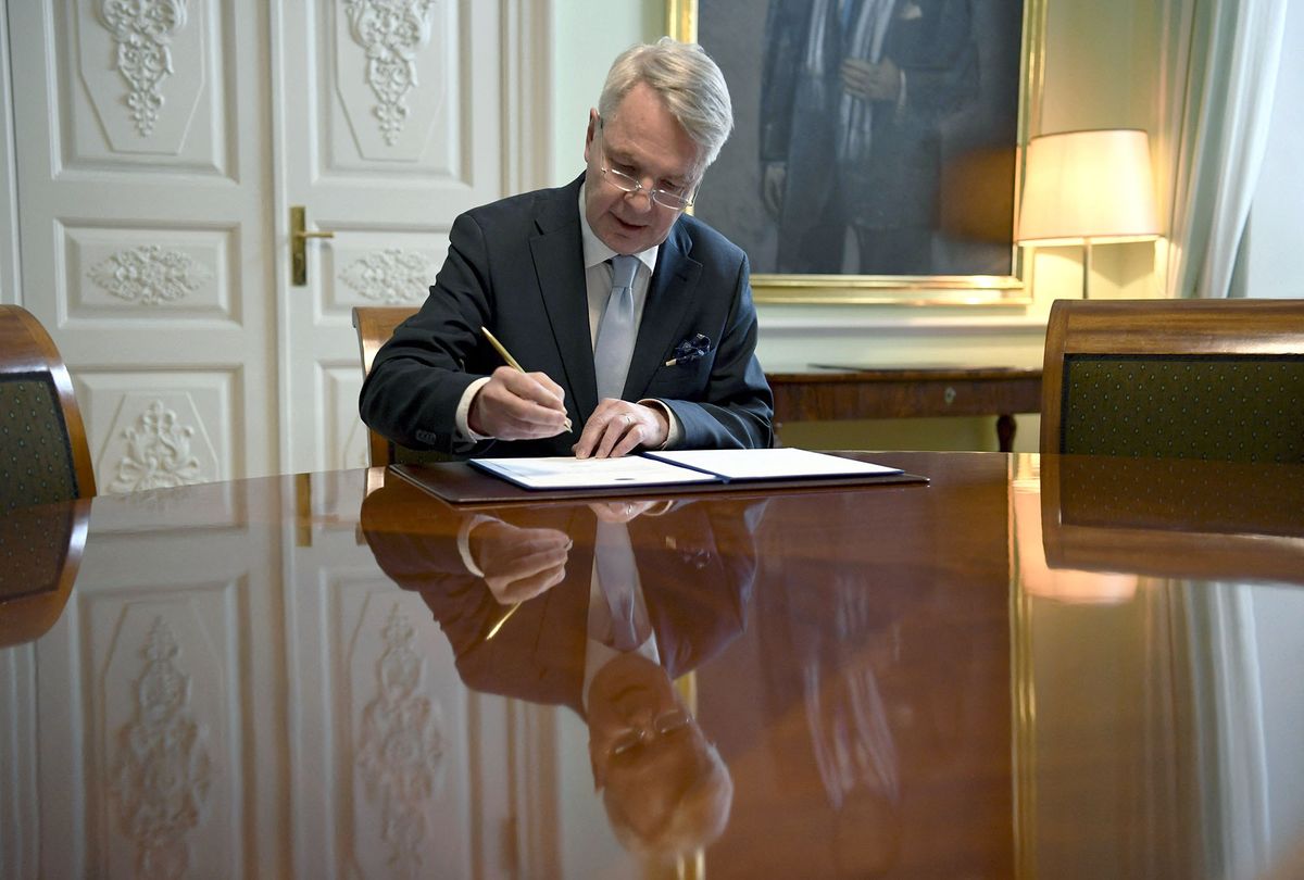 Finnish Foreign Minister Pekka Haavisto signs a petition for NATO membership in Helsinki on May 17, 2022. - Finland and Sweden will submit their bids to join NATO together on May 17 at the military alliance's headquarters in Brussels, Swedish Prime Minister Magdalena Andersson said. (Photo by Antti Aimo-Koivisto / Lehtikuva / AFP) / Finland OUT