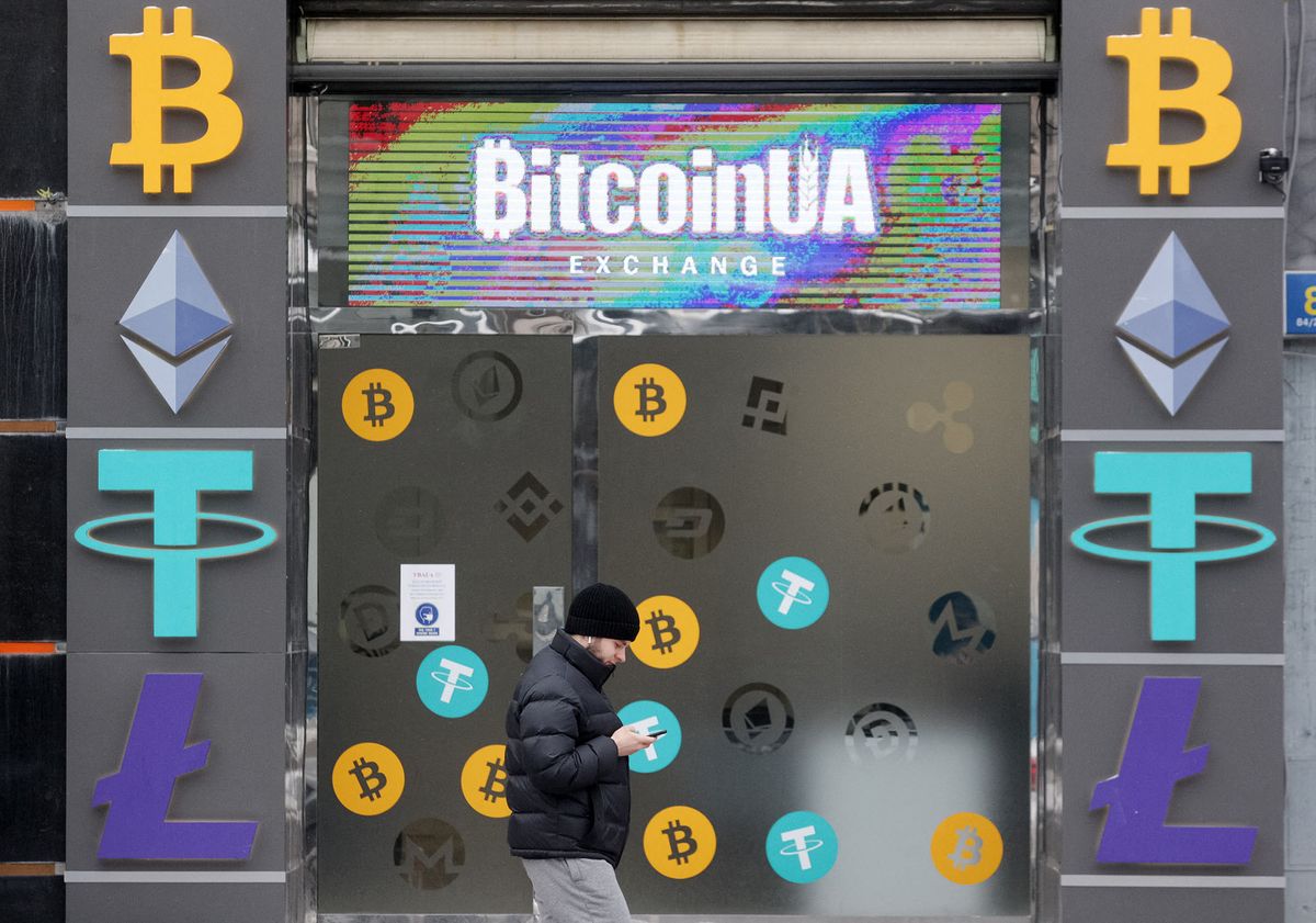 A man walks past a cryptocurrency exchange point in the center of Kyiv, Ukraine on 24 January 2022. Bitcoin dropped below $34 000, to six-month low, as fears of war in Ukraine shake stock markets, according to media. (Photo by STR/NurPhoto) (Photo by NurPhoto / NurPhoto via AFP)
