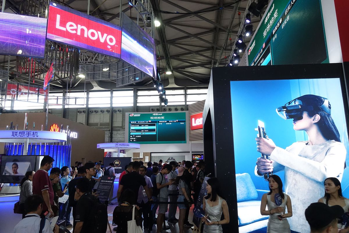 --FILE--People visit the stand of Lenovo during an expo in Shanghai, China, 14 June 2018.Chinese tech giant Lenovo Group Ltd is stepping up its digital transformation, hoping to grow and transform its business by better utilizing cutting-edge technologies to achieve broader strategic goals, its chief information officer said. "The economic growth slowdown in China is not dampening companies' enthusiasm to push forward digital transformation. Instead, the process can help them better compete in the future," Arthur Hu said. According to him, companies tend to invest less when faced with greater uncertainty. When companies are less sure of where future demand is, they are unlikely to make significant investments, for example, building a new factory that would create new capacity, or hiring employees to deliver more services. "But investment in digitalization is different from that sort of capital expenditure. It is meant to help companies better compete in the future," Hu said. Digitalization can help boost operational efficiency, optimize services and identify new products or markets. It is a long-term strategy rather than a short-term adjustment in production capacity, the senior executive added. (Photo by dycj / Imaginechina / Imaginechina via AFP)