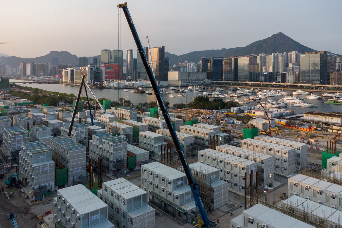This aerial view photo shows the construction site of a temporary isolation facility to house Covid-19 patients being built at Kai Tak Cruise Terminal in Hong Kong on April 6, 2022. (Photo by Yan ZHAO / AFP)