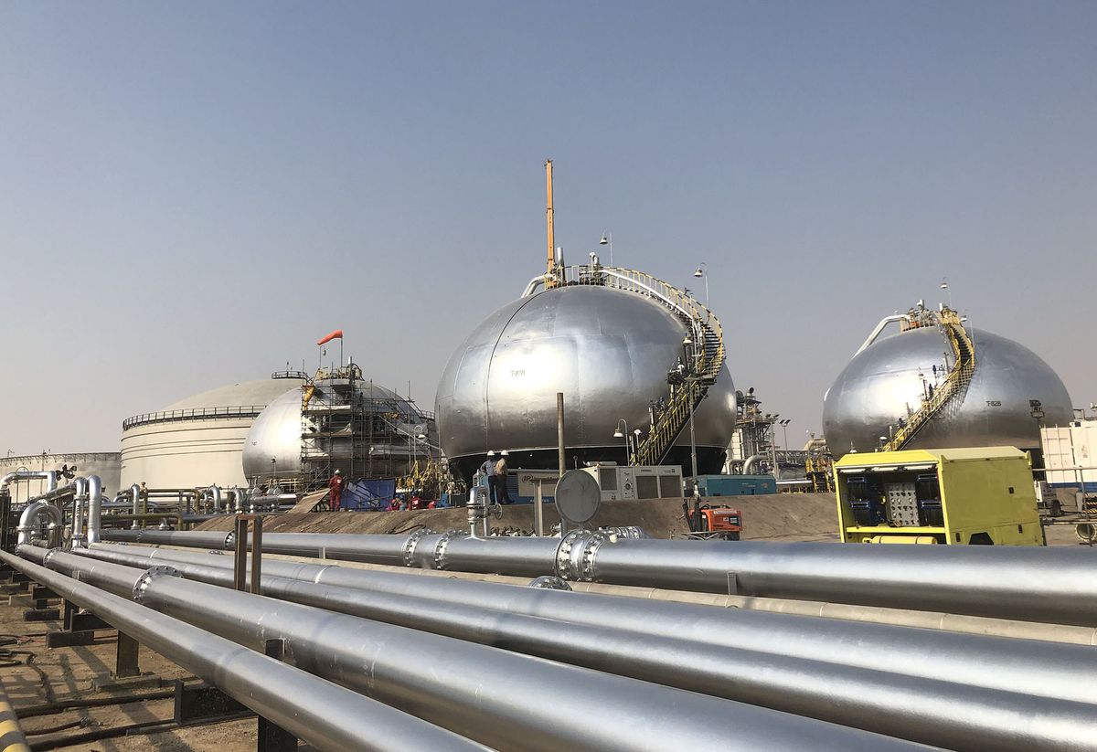 (EDITORS NOTE: Best Quality Available. Image was created with a mobile.) Three-phase spheroids stand behind pipelines at Saudi Aramco's crude oil processing facility, in Abqaiq, Saudi Arabia, on Saturday, Oct. 12, 2019. Aramco showed it has made significant progress in restoring damaged oil infrastructure to normal operation just a month after a devastating aerial attack halted production. Photographer: Dina Khrennikova/Bloomberg via Getty Images 1186568145