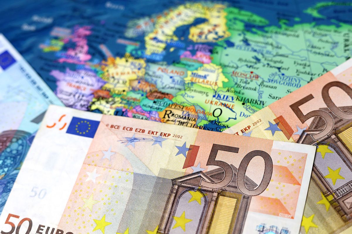 Euro banknotes on the map of Europe. Concept of Eurozone, European economy, EU financial support of Ukraine