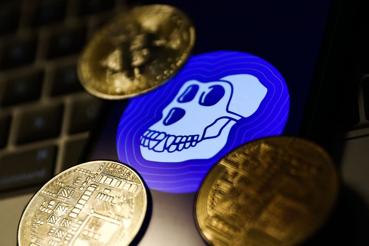 ApeCoin logo displayed on a phone screen, representation of cryptocurrencies and a laptop keyboard are seen in this illustration photo taken in Krakow, Poland on April 19, 2022. (Photo by Jakub Porzycki/NurPhoto) (Photo by Jakub Porzycki / NurPhoto / NurPhoto via AFP)