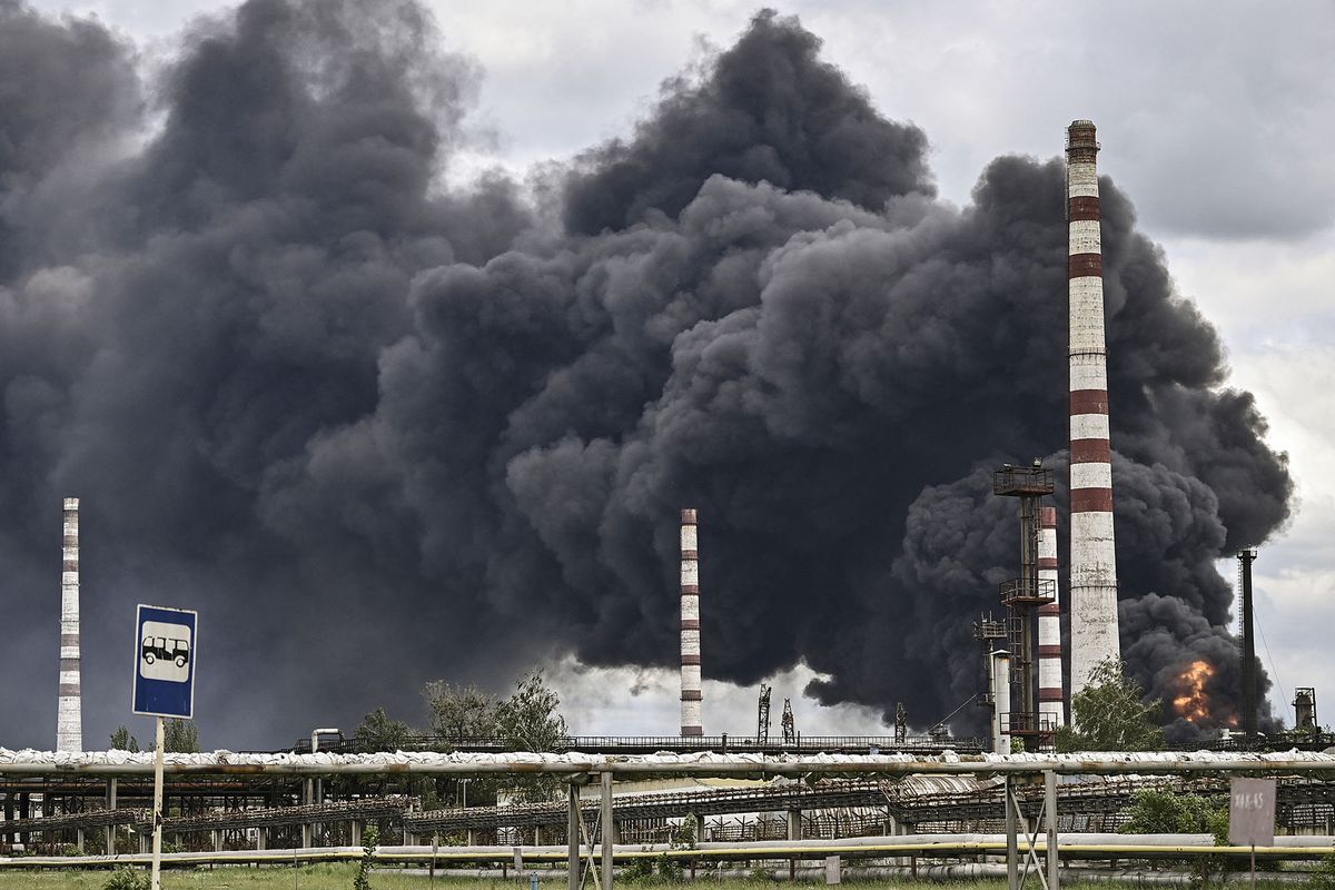 Smoke rises from an oil refinery after an attack outside the city of Lysychansík in the eastern Ukranian region of Donbas, on May 22, 2022, on the 88th day of the Russian invasion of Ukraine. (Photo by ARIS MESSINIS / AFP)