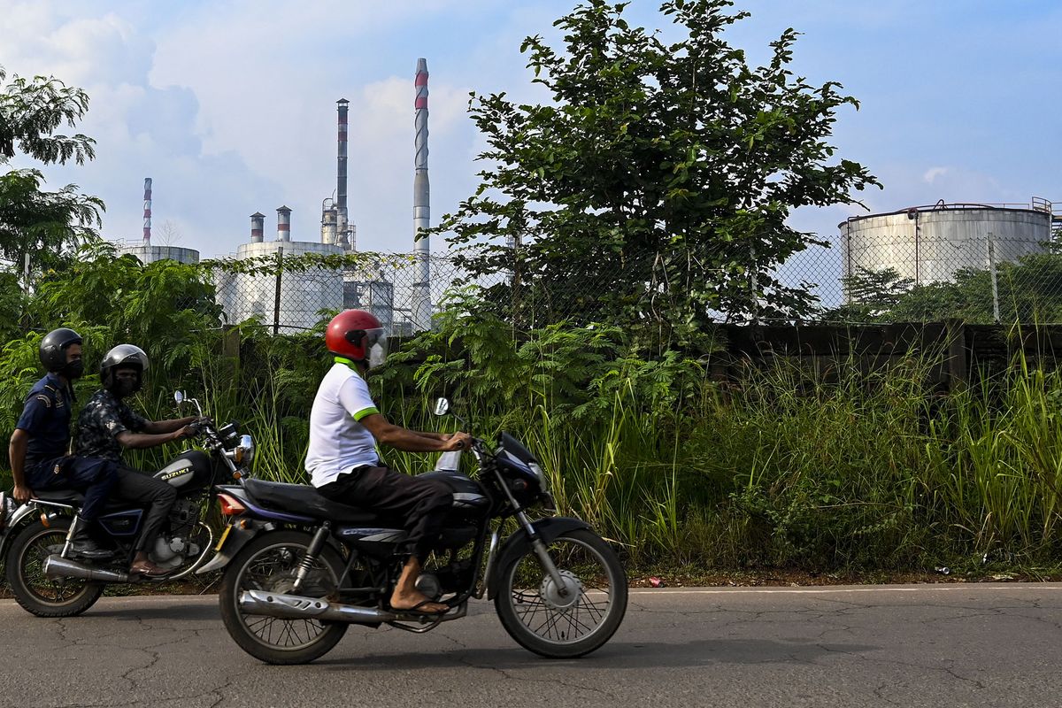Motorists ride past Sri Lankaís only refinery at Sapugaskanda on November 17, 2021, two days after it was shut down as the government ran out of dollars to import crude oil. (Photo by ISHARA S. KODIKARA / AFP)