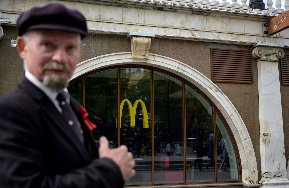 An impersonator of the Soviet State founder Vladimir Lenin stands in front of a closed McDonald's restaurant in Moscow on May 16, 2022. - American fast-food giant McDonald's will exit the Russian market and sell its business in the increasingly isolated country, the company said May 16, 2022. In a statement McDonald's said: "After more than 30 years of operations in the country, McDonald's Corporation announced it will exit the Russian market and has initiated a process to sell its Russian business. Many Western businesses have pulled out of Russia since its invasion of Ukraine in February. (Photo by Natalia KOLESNIKOVA / AFP)