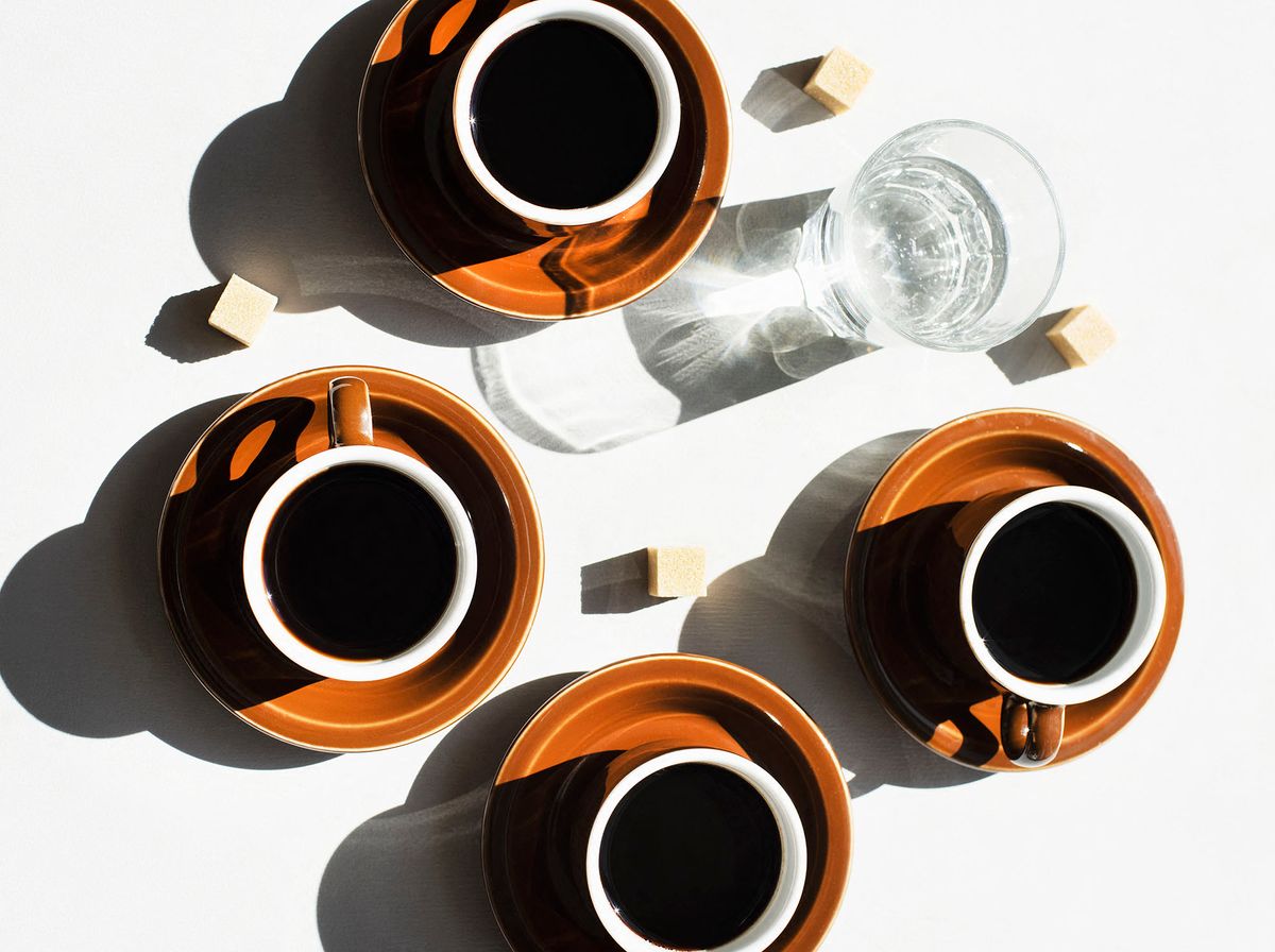 Overhead view of espresso cups and glass of water (Photo by Magdalena Niemczyk - ElanArt / Image Source / Image Source via AFP)