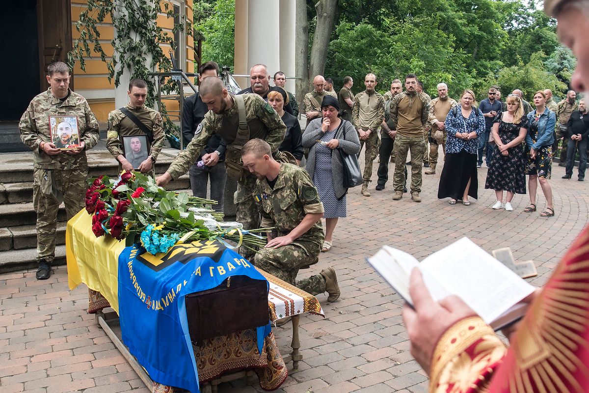 Relatives, friends and comrades attend the funeral ceremony for Ukrainian serviceman Mykhailo Tereshchenko, who was killed in the Donbas region, outside the St. Nicholas church in Kyiv, Ukraine, June 14, 2022 (Photo by Maxym Marusenko/NurPhoto) (Photo by Maxym Marusenko / NurPhoto / NurPhoto via AFP)